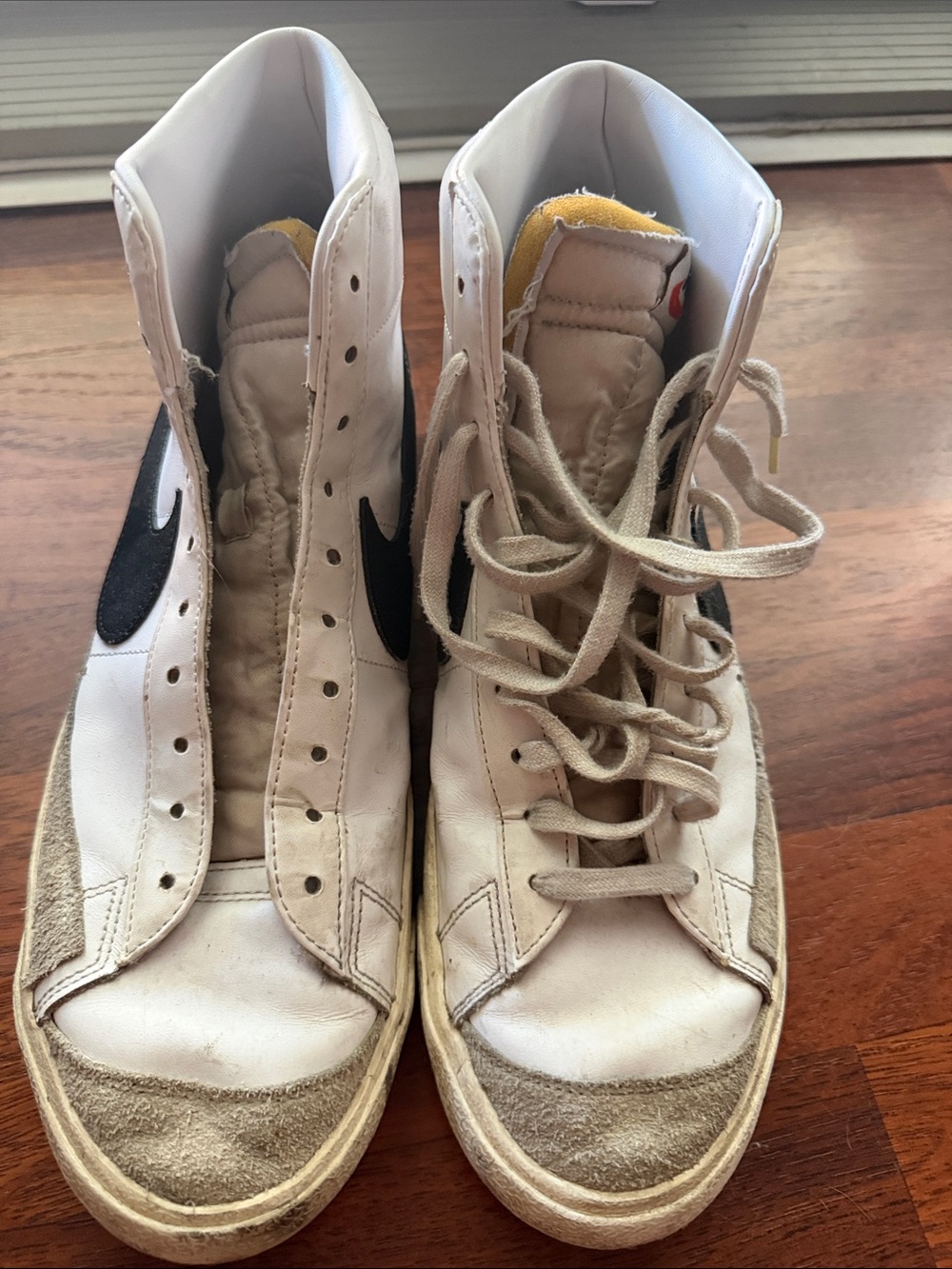 Nike White High-Top Sneakers with Black Swoosh and Yellow Tongue Accent